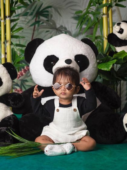Can you spot the real panda? This cool little dude is blending in perfectly with his fluffy friends.