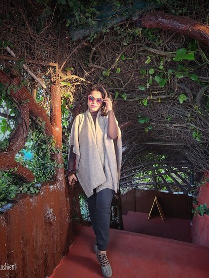 Good basics are the foundation of any wardrobe. A simple poncho over black pants is a timeless and comfortable outfit.