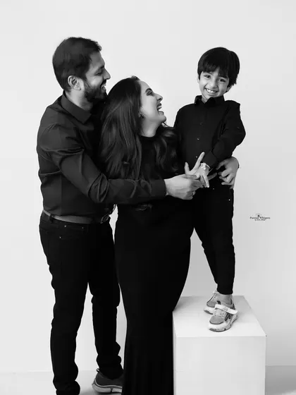Pure, uninhibited joy captured in classic black and white. This candid moment shows how removing color can amplify the emotion, focusing on the laughter and love that define a family.