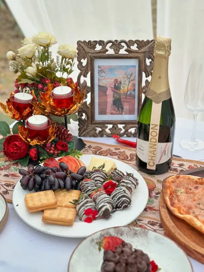 A close-up of the gourmet dining experience that awaits. We offer curated platters with items like chocolate-covered strawberries, cheese, crackers, and champagne to make your celebration extra special.