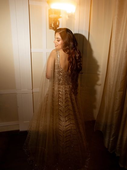 A creative shot showing the back of her gown and the beautiful, soft lighting.