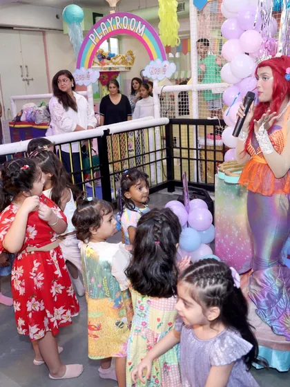 The look of pure wonder on a child's face is what we live for. Here, a group of young guests are completely captivated as they meet and interact with our beautiful mermaid character during a themed party.
