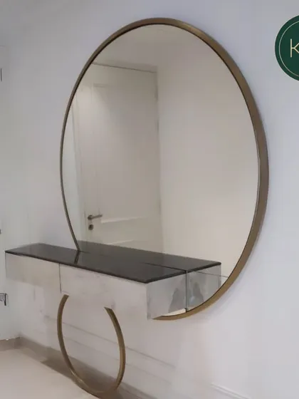 A bespoke dressing area is a personal luxury. We designed this floating console and oversized circular mirror for the prestigious Paras Quartier collection, combining minimalist form with a striking gold-finished frame to create a functional and glamorous vanity space.