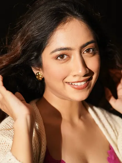 A happy, smiling portrait that showcases the beauty of a natural look. The hair is soft and loose, and the makeup is fresh and light.