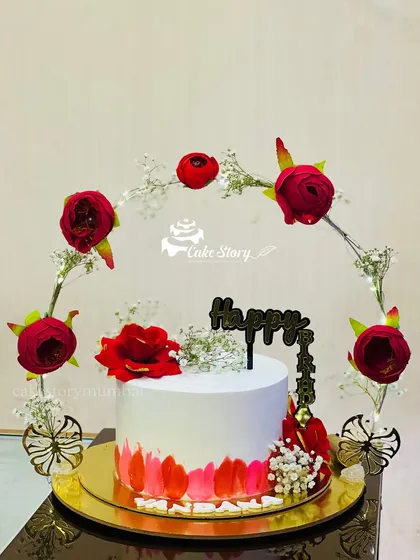 A unique 'frame cake' design. The cake is encircled by a beautiful, light-up floral frame, creating a stunning and memorable presentation.