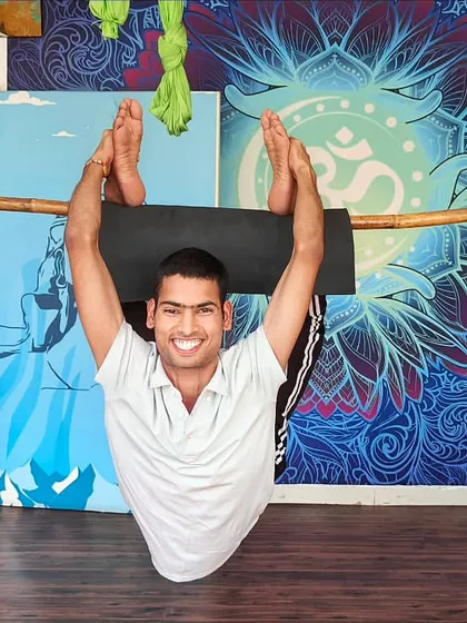 We creatively use props like this bamboo stick to help students safely explore advanced backbends. This method provides support while building the core strength and spinal flexibility needed for challenging asanas, making them accessible to more practitioners.