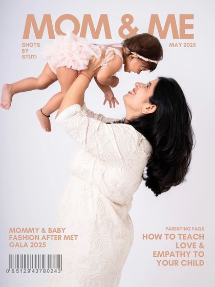 A "Mom & Me" magazine cover concept. This playful shot of a mother lifting her baby in the air captures the joy and energy of motherhood, perfect for celebrating moms.