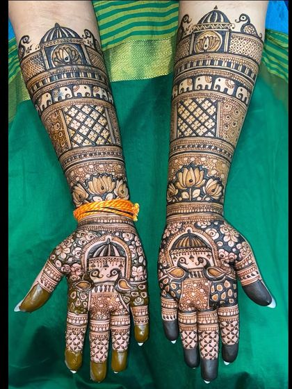 A dark-stained version of the royal Rajasthani mehandi, showing the beautiful contrast and detail of the palace, doli, and elephant motifs.