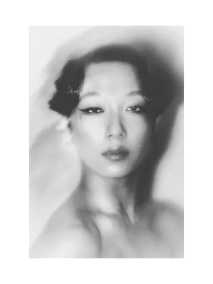 An experimental black and white portrait of Patricia. The motion blur and soft focus create an abstract, ghost-like image that is both beautiful and haunting.