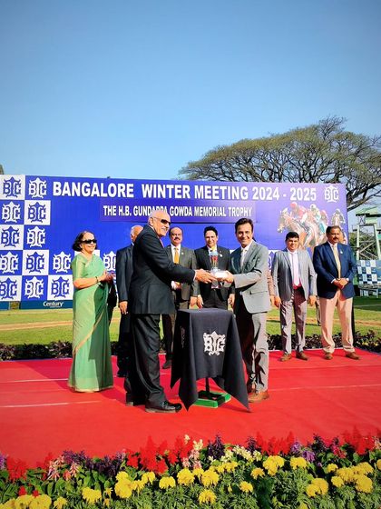 A moment of honor at the H.B. Gundappa Gowda Memorial Trophy ceremony.