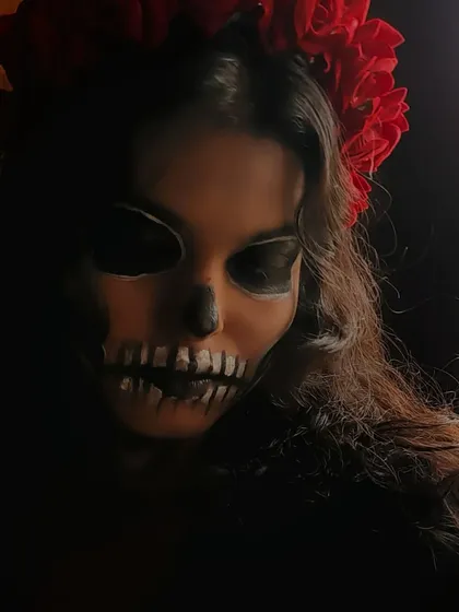 In low light, the Calavera Catrina makeup takes on an even more haunting and dramatic quality. I love playing with lighting in photoshoots to enhance the mood of the styling.