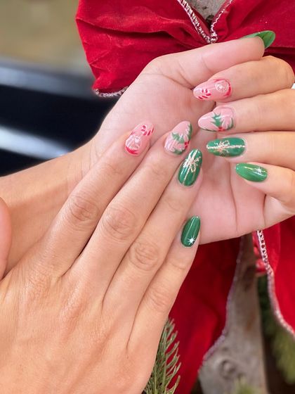 A full view of a festive manicure, showcasing intricate holiday designs across both hands, perfect for celebrating the season.