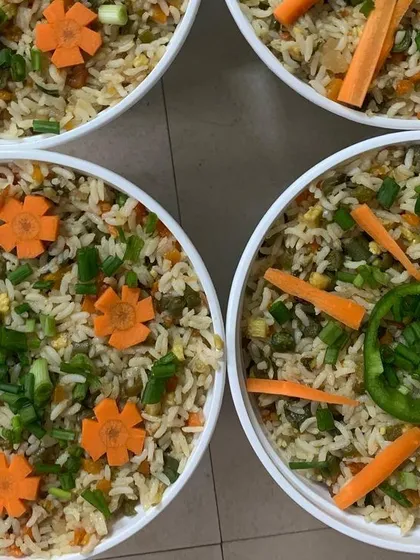 Beautifully garnished Veg Fried Rice with carrot flowers.