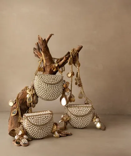 A potli bag is more than an accessory; it's a treasure. This artistic display highlights my collection of pearl-encrusted mini bags, perfect for adding a touch of classic charm to any festive look.