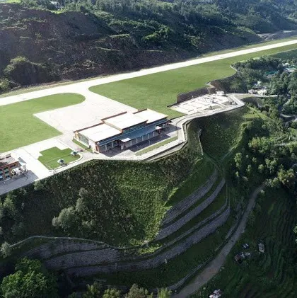 A wider view of the Pakyong Airport, showing the terminal building set against the massive, terraced retaining walls we engineered. This was one of the tallest reinforcement walls in the world, a solution born from the need to work with, not against, the challenging Himalayan terrain. It highlights how engineering and nature can coexist.