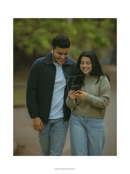 Walking and sharing a song, this candid moment from a pre-wedding shoot feels natural and full of easygoing love.