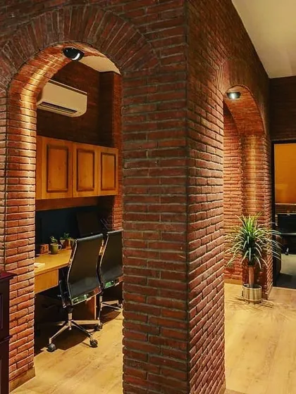 For this office at Sushma Buildtech, the goal was a warm and classic feel. I used focused downlights within the brick arches to create pools of light over workstations, combining the industrial texture of the brick with a comfortable, focused work environment.