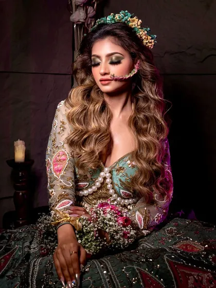 A stunning floral look, perfect for a Mehendi or pre-wedding shoot. The floral accessories and soft makeup create a truly beautiful image.