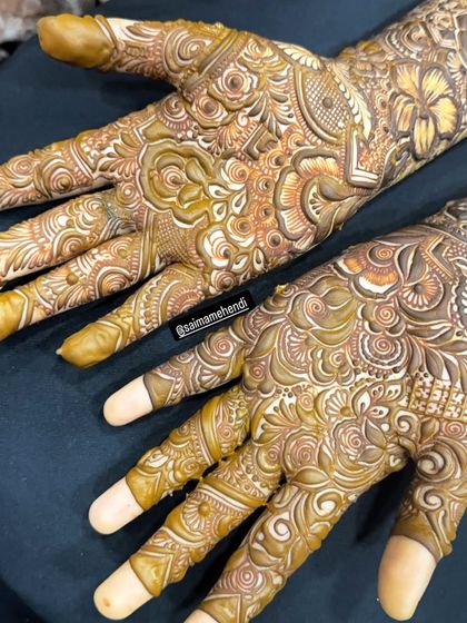 A stunning close-up of a full-hand design, showcasing the white-toned highlights that some artists use to make the pattern pop for photos before the paste is removed.