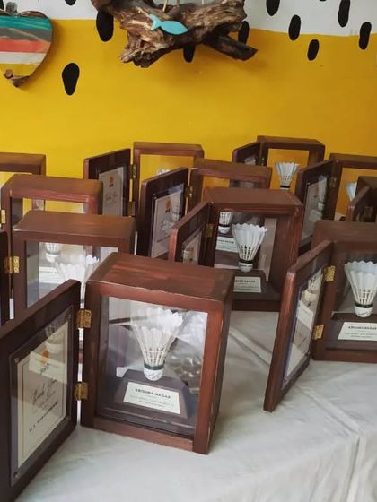 The full set of open shadow boxes, displayed in our studio. Each one is a testament to an athlete's journey and the community that supports them.