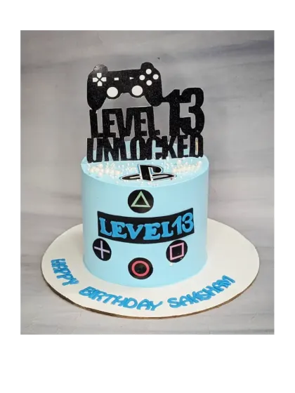 "Level 13 Unlocked!" A perfect cake for a gamer turning thirteen. This choco-chip cake is decorated with a PlayStation theme.