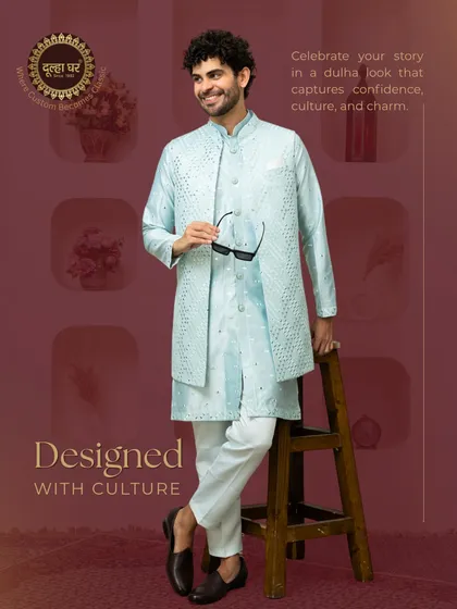 This ensemble is perfect for a daytime wedding event. A breezy, pastel blue kurta is layered with a Nehru jacket featuring intricate mirror work, offering a look that is both festive and comfortable.