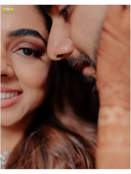 An artistic close-up that focuses on the smiles and intimacy of the couple.