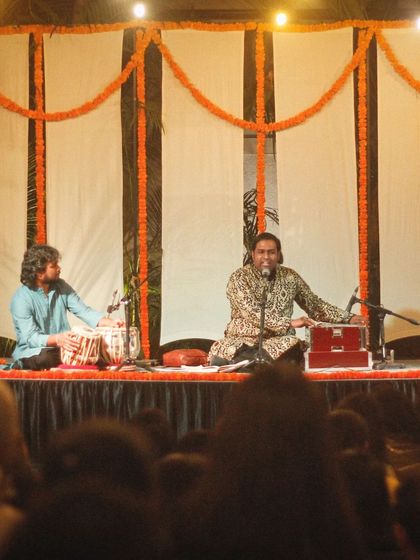 On stage with Shri Sanam Khan during a ghazal performance.