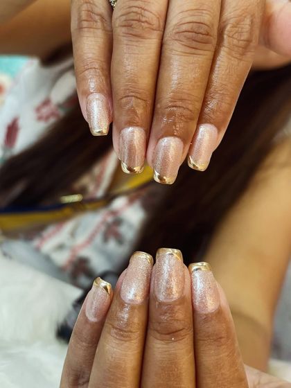 A final view of the elegant and shimmering gold-tipped manicure.