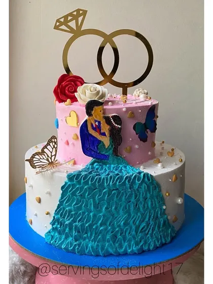 A two-tier engagement cake featuring a hand-painted couple and a ruffled buttercream dress effect. This is a great example of my custom cake art.