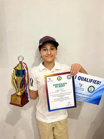 Aaliyah Kalra proudly displays her winner's trophy and qualification certificate for the Taiwan Junior Open.