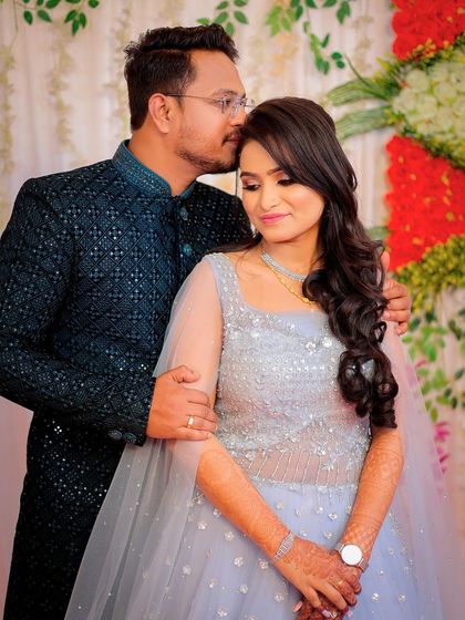 An intimate moment with the groom kissing his fiancée's forehead.