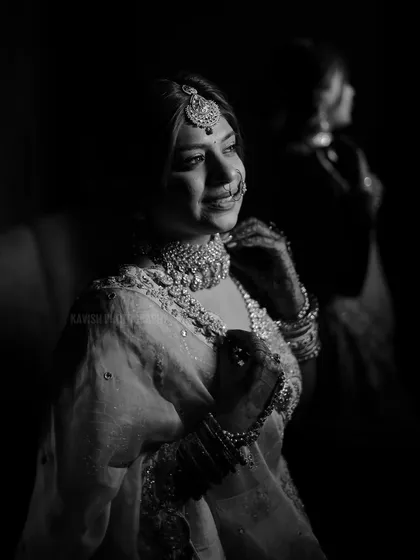 A smiling bridal portrait in black and white, showcasing her joy and the timeless beauty of the monochrome style.
