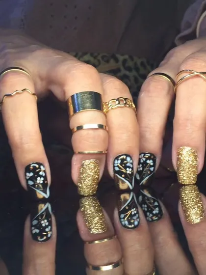Another angle of the intricate black, white, and gold floral and glitter design.