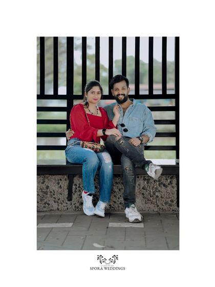 A relaxed portrait of the couple seated on a bench, a perfect, simple shot from their pre-wedding session.