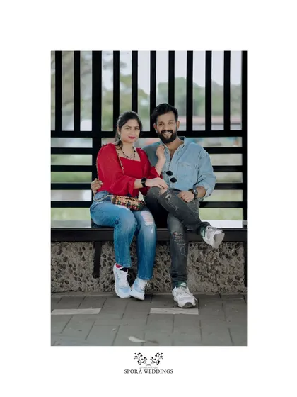 A relaxed portrait of the couple seated on a bench, a perfect, simple shot from their pre-wedding session.