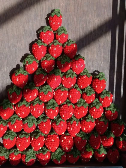 A pyramid of crochet strawberries, showing the quantity I can produce for bulk orders.