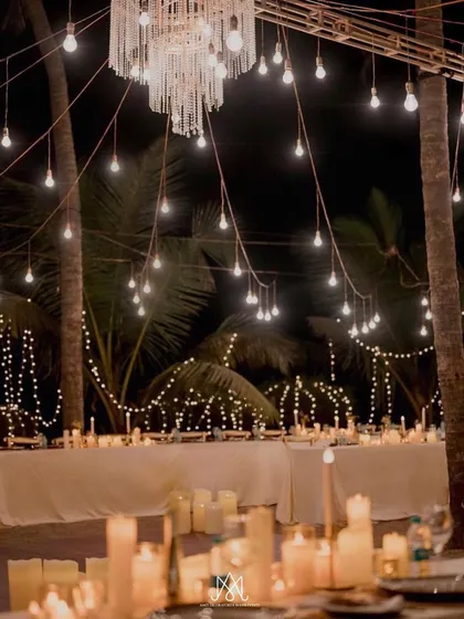 The long dining tables lit by candles and chandeliers, creating an incredibly intimate and dreamy atmosphere for the guests.