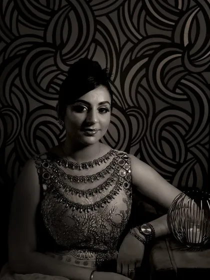This is an example of a dramatic, artistic portrait from a studio session. The use of shadow and a monochrome finish creates a powerful and elegant image, perfect for individual portraits.
