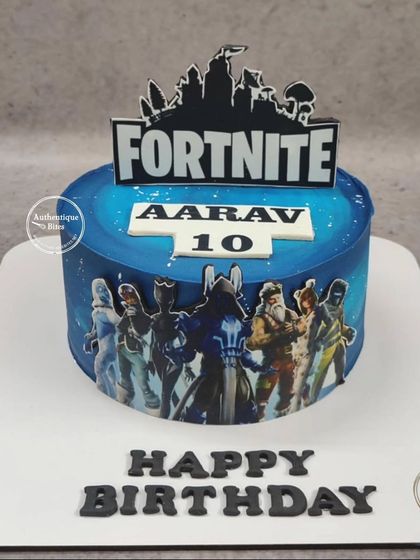 A sleek Fortnite cake for a 10th birthday. The cake is wrapped in an edible image of Fortnite characters with the game's logo on top.