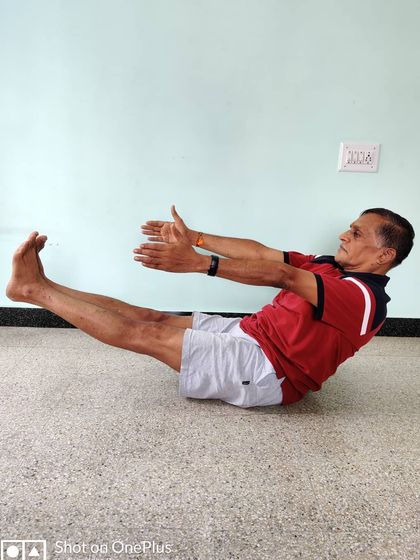 Paripurna Navasana (Full Boat Pose). This asana is a powerful tool for building core strength and mental endurance. The spine must remain straight, not rounded.