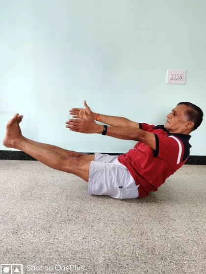 Paripurna Navasana (Full Boat Pose). This asana is a powerful tool for building core strength and mental endurance. The spine must remain straight, not rounded.