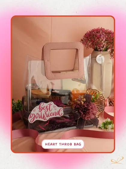 The 'Heart Throb Bag' is a modern and stylish choice. This clear bag with a pink frame handle holds chocolates and other goodies, with a "best girlfriend" tag to make her feel extra special.