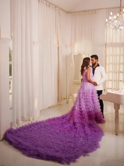 For a true fairytale moment, this breathtaking lavender gown with a dramatic ruffled trail is the ultimate choice. The ombre effect and voluminous design are perfect for a pre-wedding photoshoot or a grand reception entrance. Renting this lets you have that high-fashion moment without the high cost.