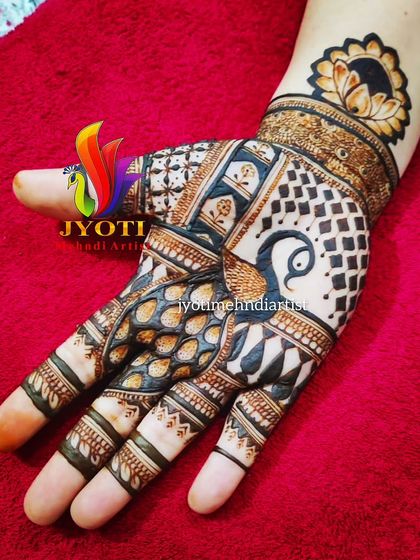 A creative design featuring a peacock with its feathers forming a dense, patterned fill on the palm. The lotus cuff on the wrist completes this unique piece.