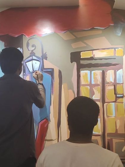 Here, you can see me actively working on the mural, adding details to the street lamp and background elements. This demonstrates the hands-on process of bringing the artwork to life.