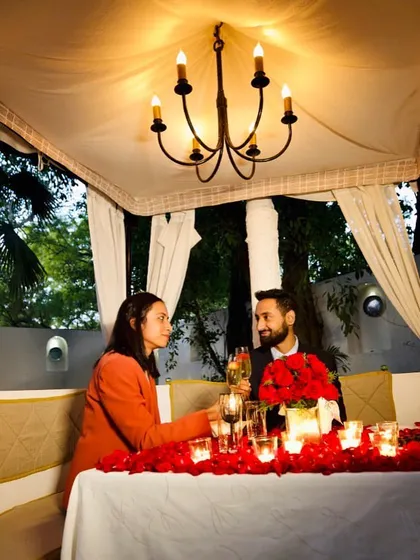 A couple enjoying their special celebration in one of our decorated cabanas, sharing a toast to their memorable evening.
