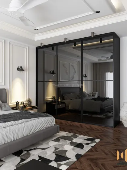 A sleek, modern classic bedroom with a black tinted glass sliding wardrobe that reflects the space and adds a touch of drama.
