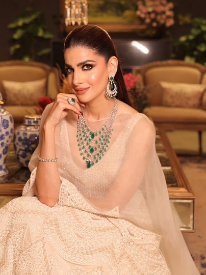 A seated portrait that captures the grace and poise of the modern bride, with makeup that enhances her natural beauty.