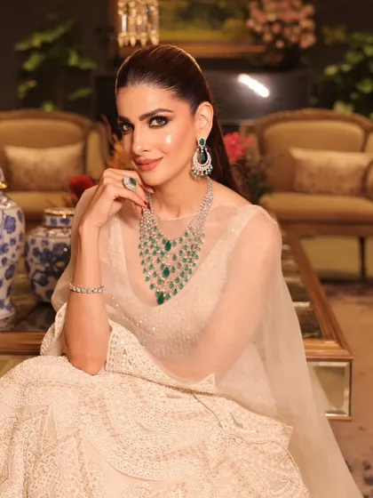 A seated portrait that captures the grace and poise of the modern bride, with makeup that enhances her natural beauty.